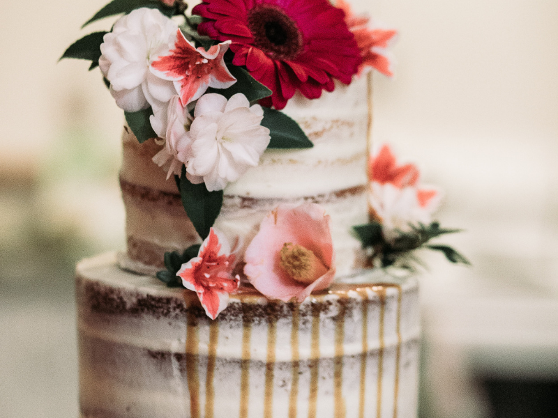 rustic wedding cake with naked frosting and flowers