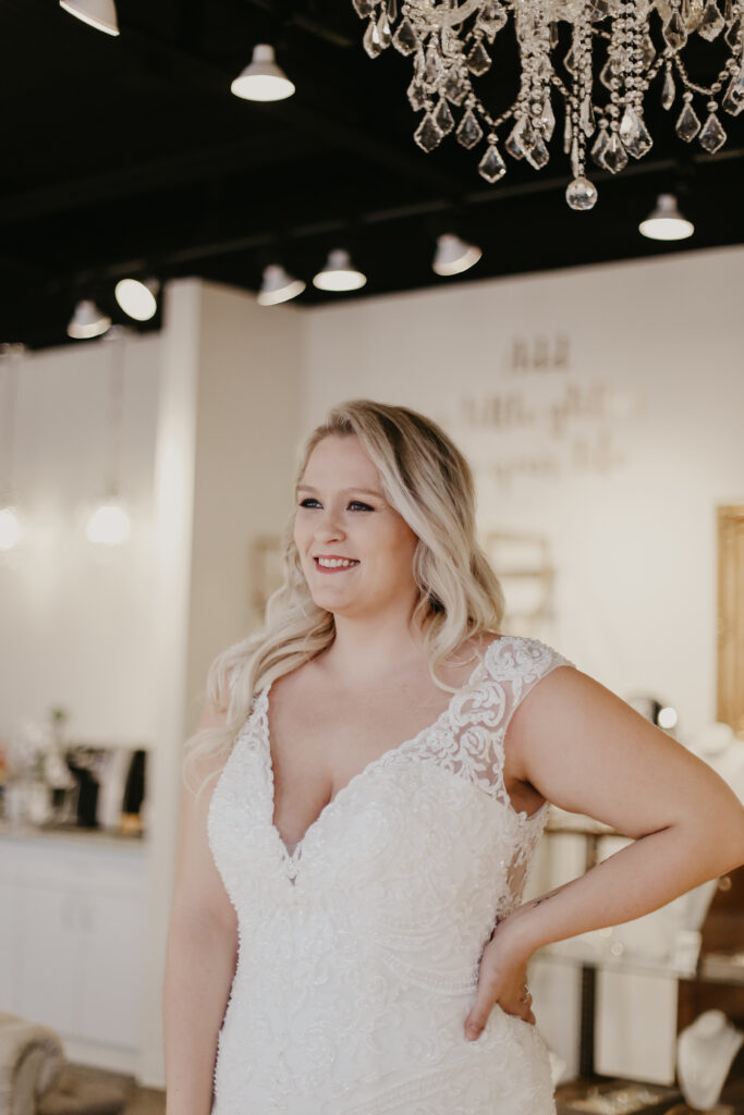 Blonde woman wearing a plus size wedding gown wedding shoppe berkley mi