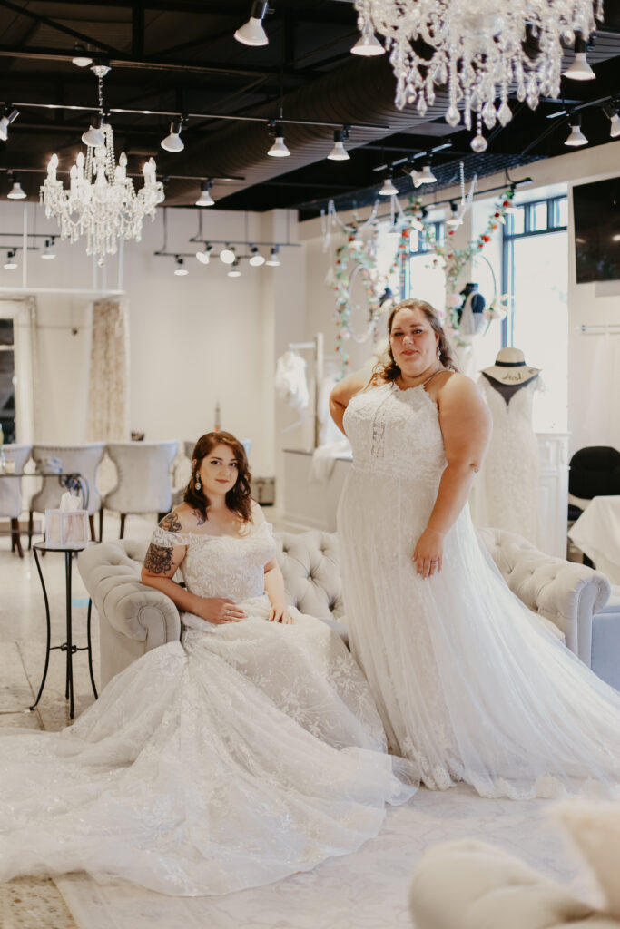 two women posing in white plus sized wedding gowns the wedding shoppe berkley mi