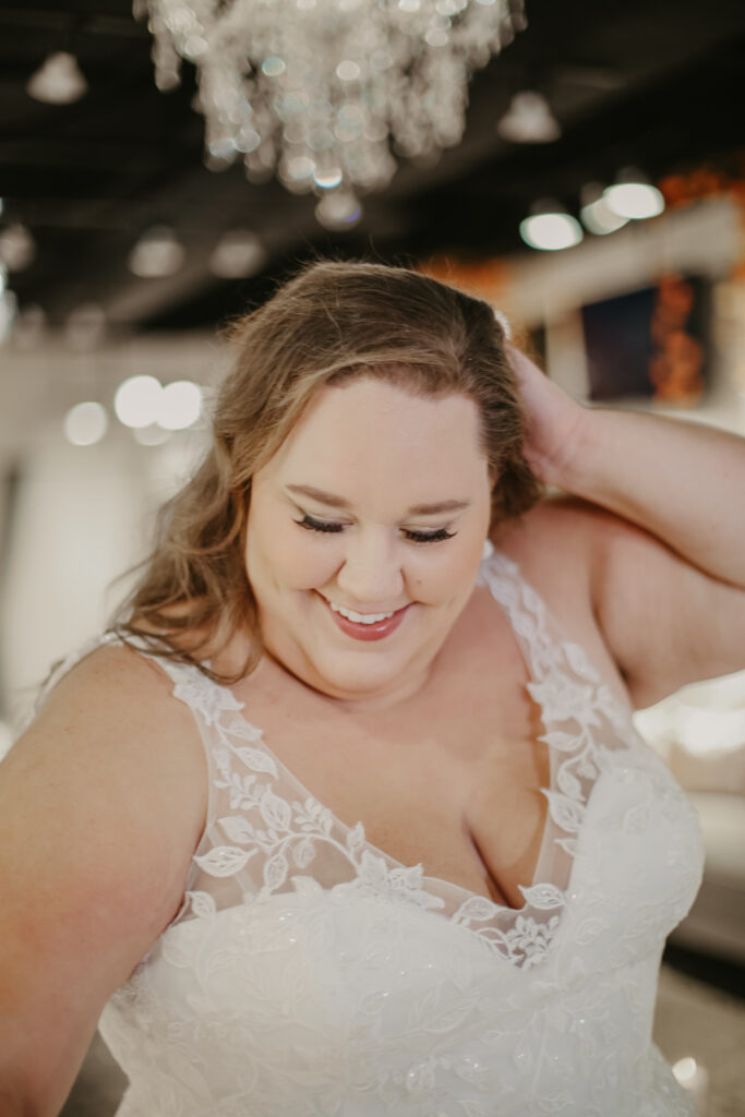 bride posing in plus size bridal gown with unique detailing