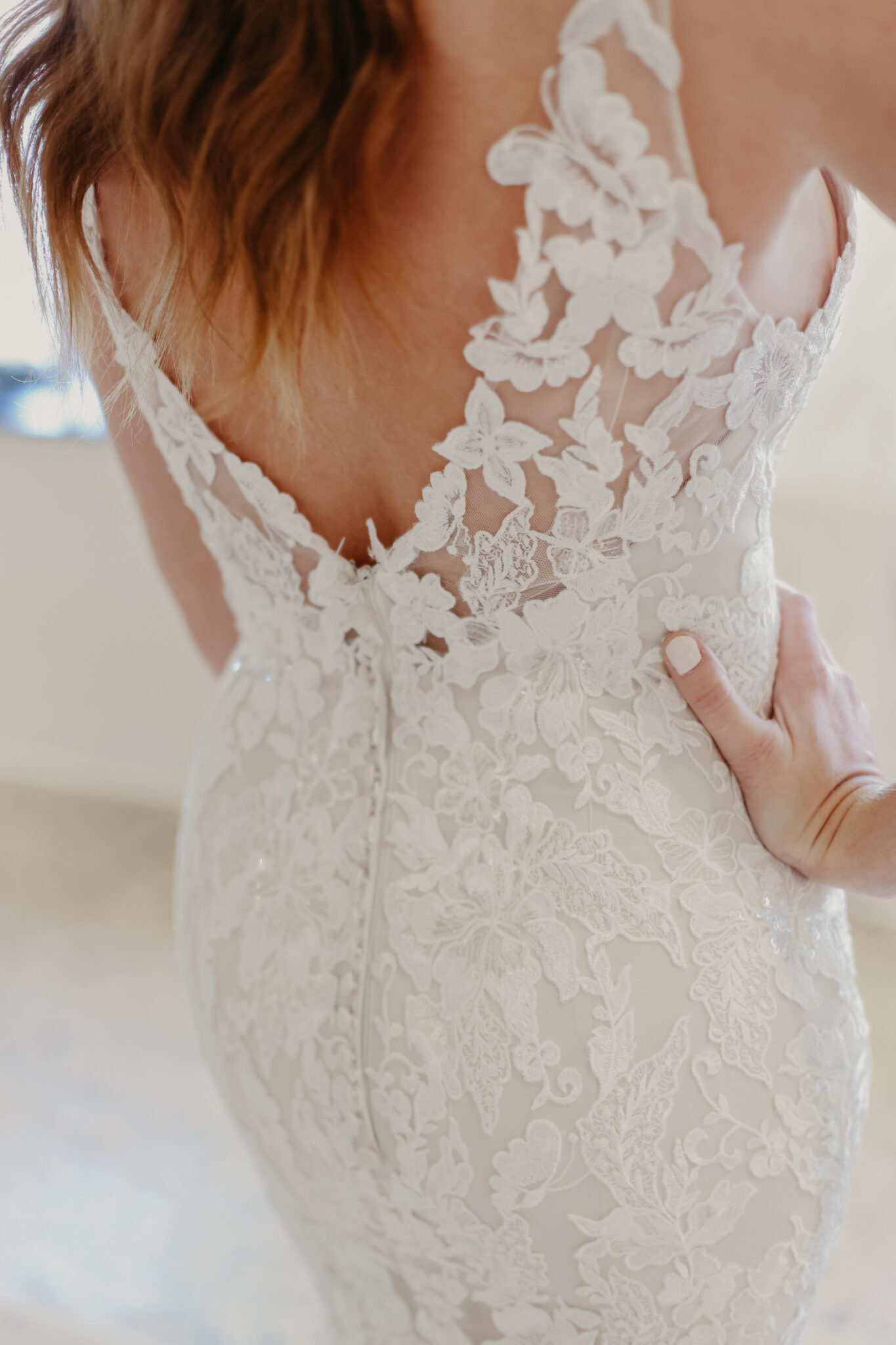 open back white wedding gown with floral lace details