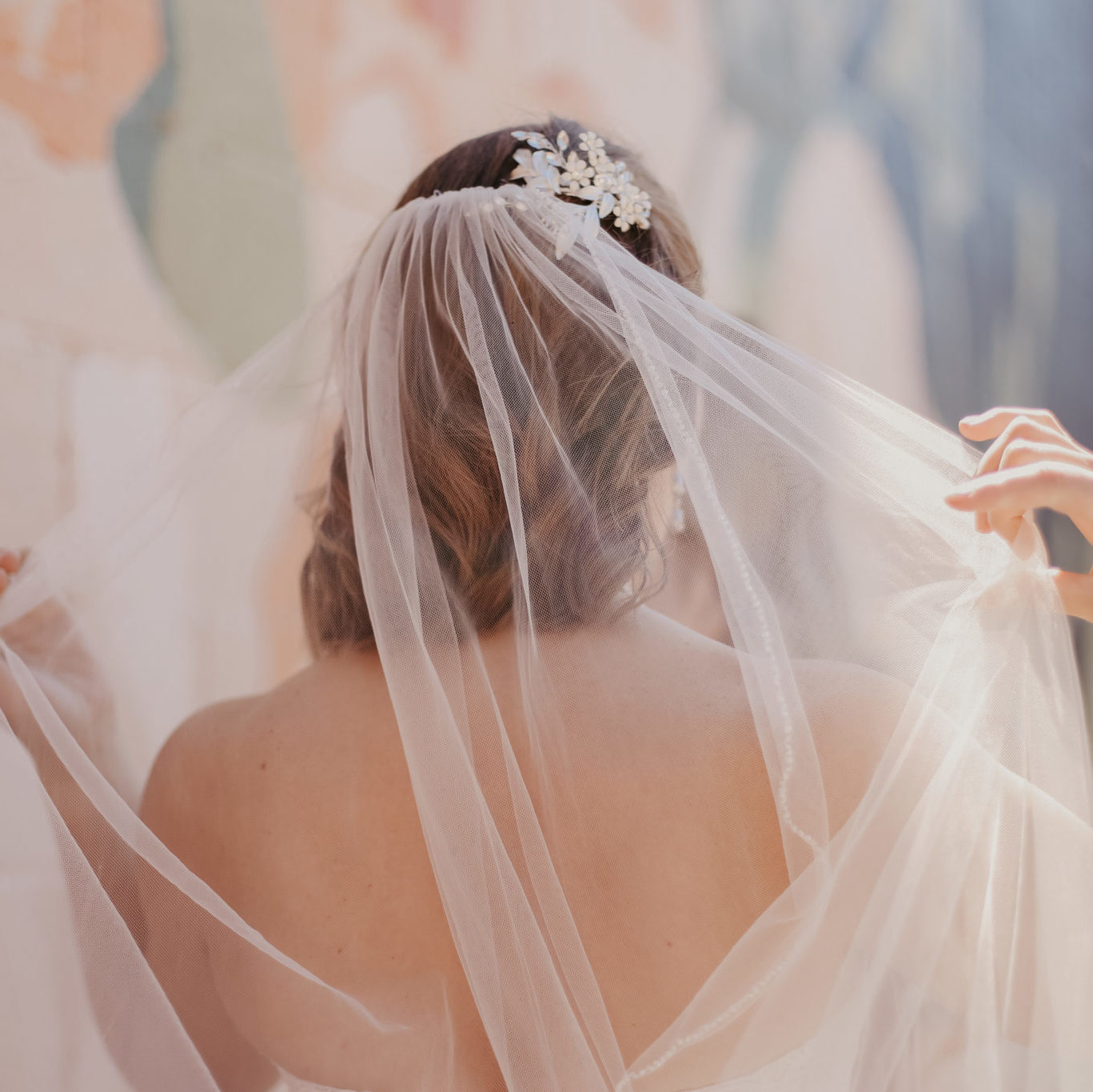bride spreading out wedding veil behind her head