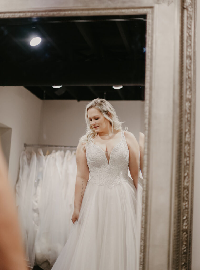 plus sized model wearing bridal gown with deep plunging v neck