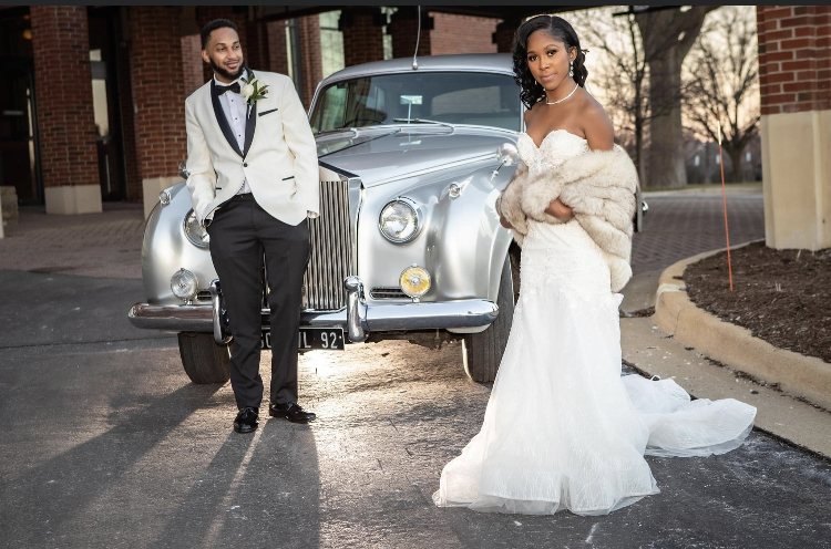 bride and groom in formal wear in front of old school gray car