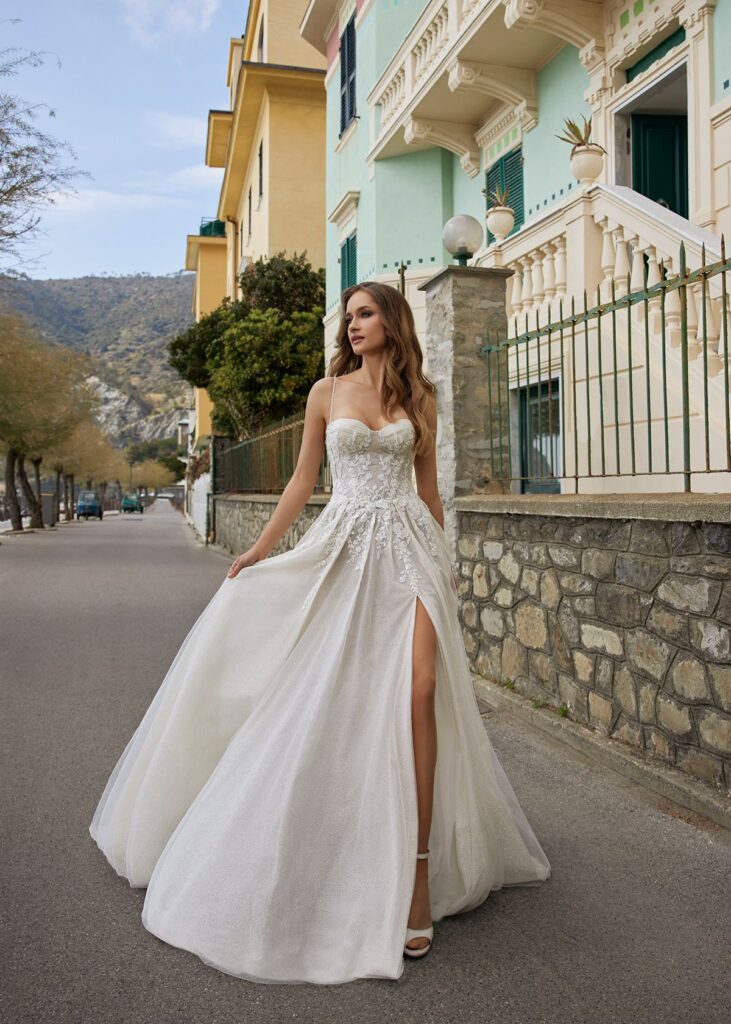 woman walking on street in bridal gown