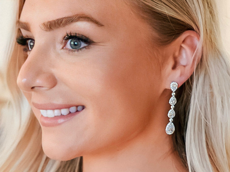 close-up of woman wearing multi-diamond earrings