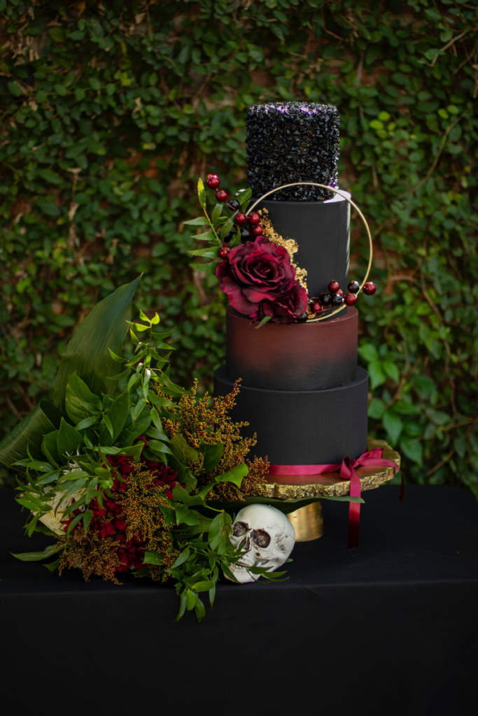 tiered wedding cake with dark decorations