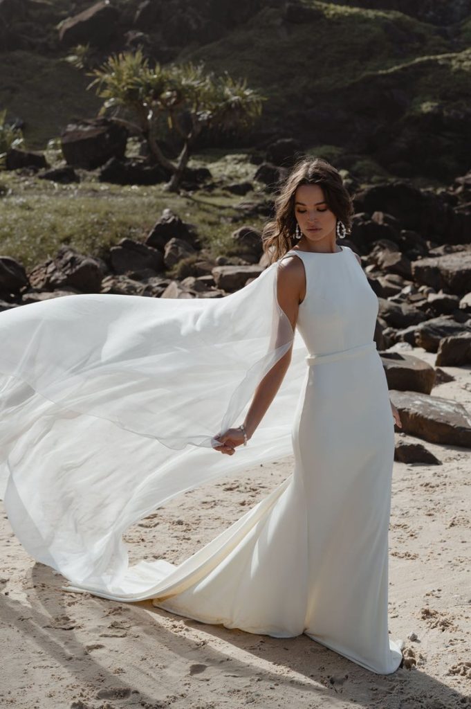 woman in Emmerson bridal gown walking on beach