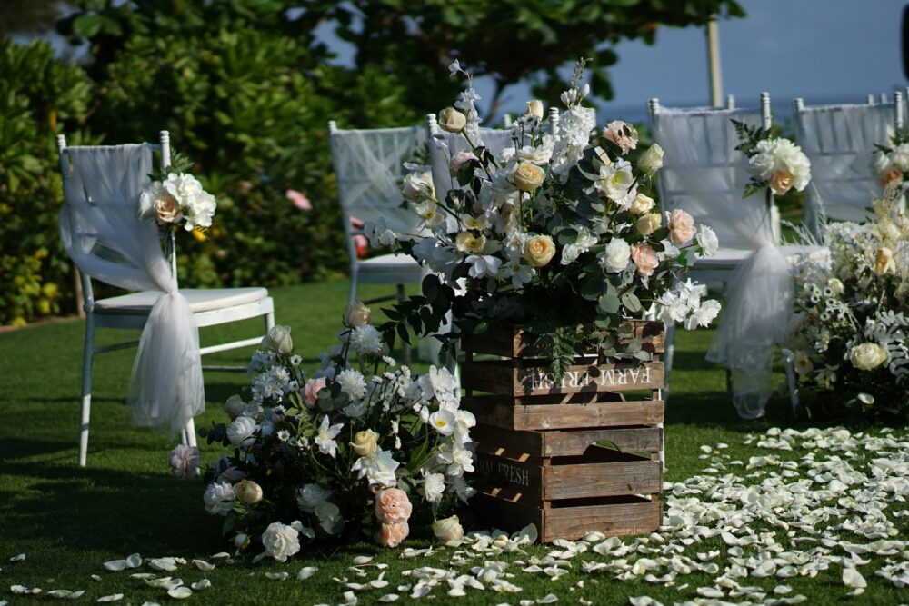 Chairs and flowers set in place for a lakeside wedding ceremony in Michigan.