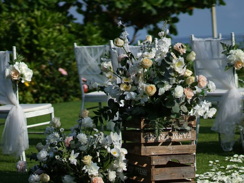 Chairs and flowers at a lakeside wedding ceremony.