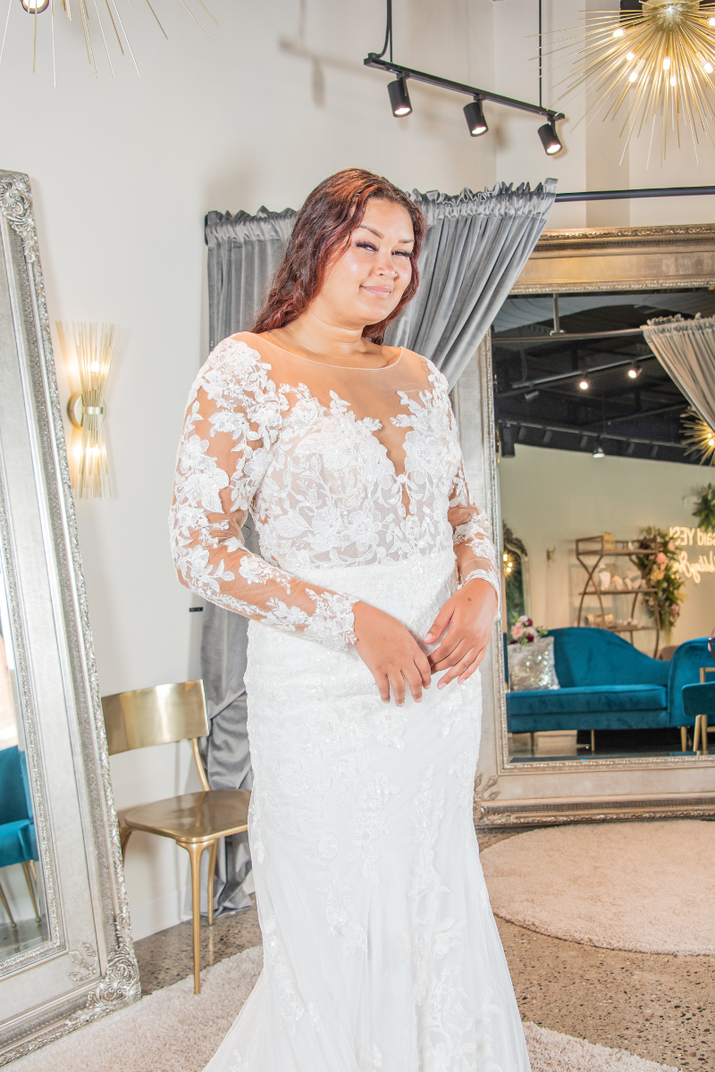 woman in white bridal gown with see-through floral sleeves