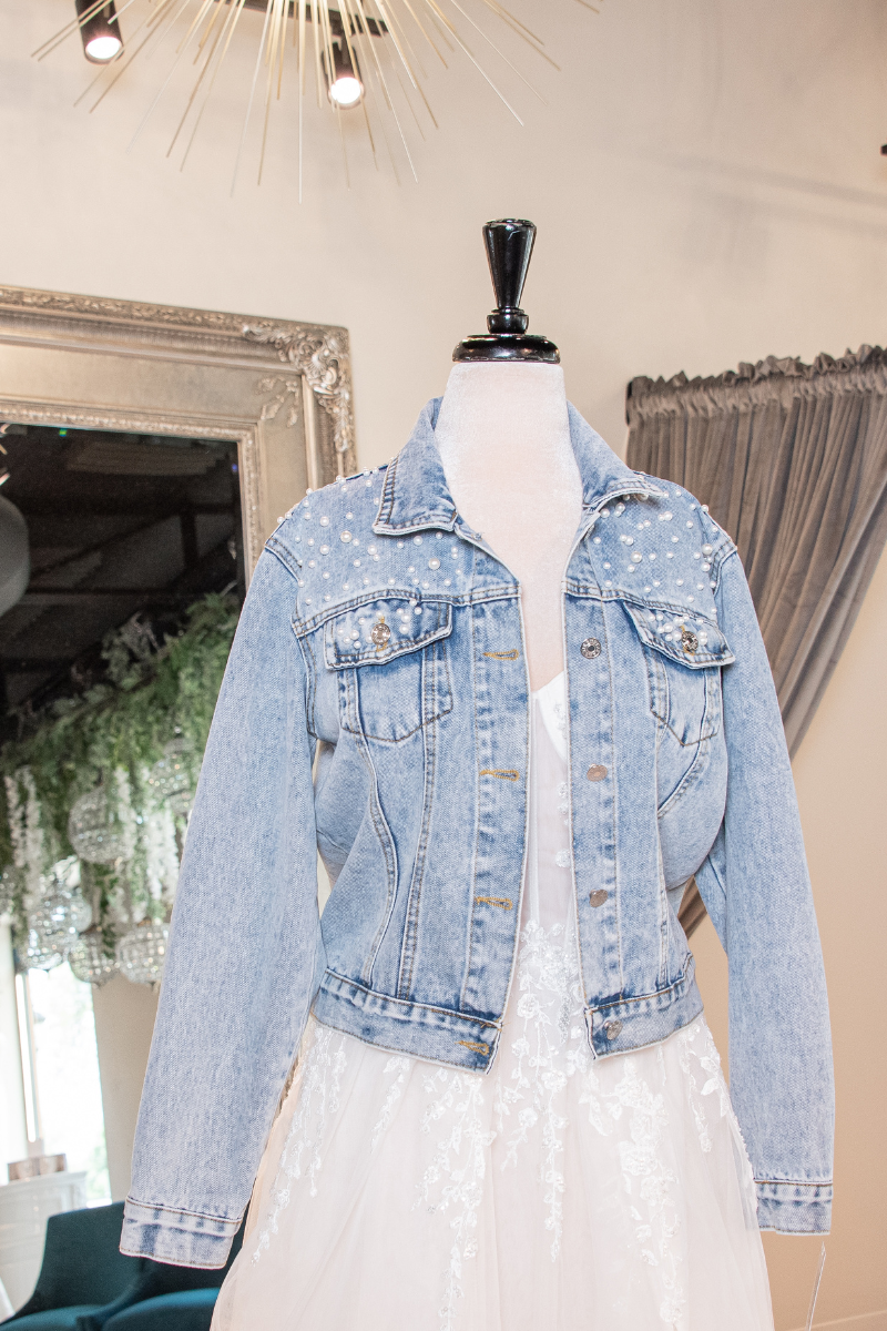 light wash denim jacket with white dotted design to wear over wedding gown