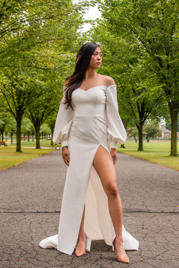 woman in white modern bridal gown standing in park