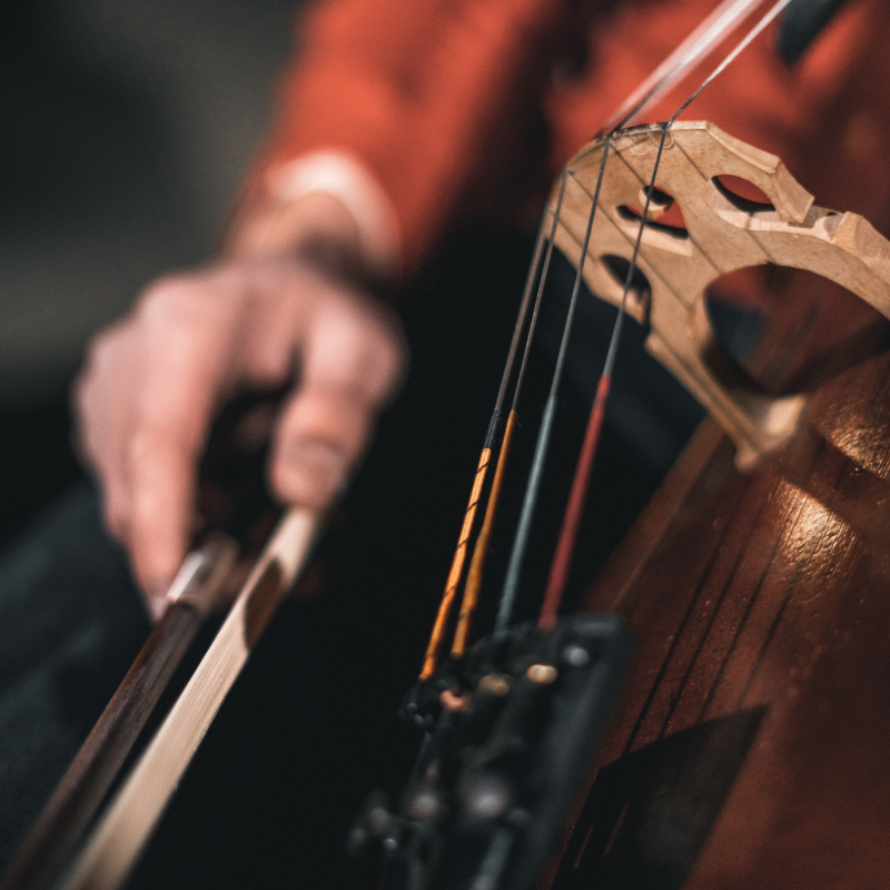 close up of person playing cello