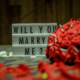 will you marry me? sign and bouquet of flowers