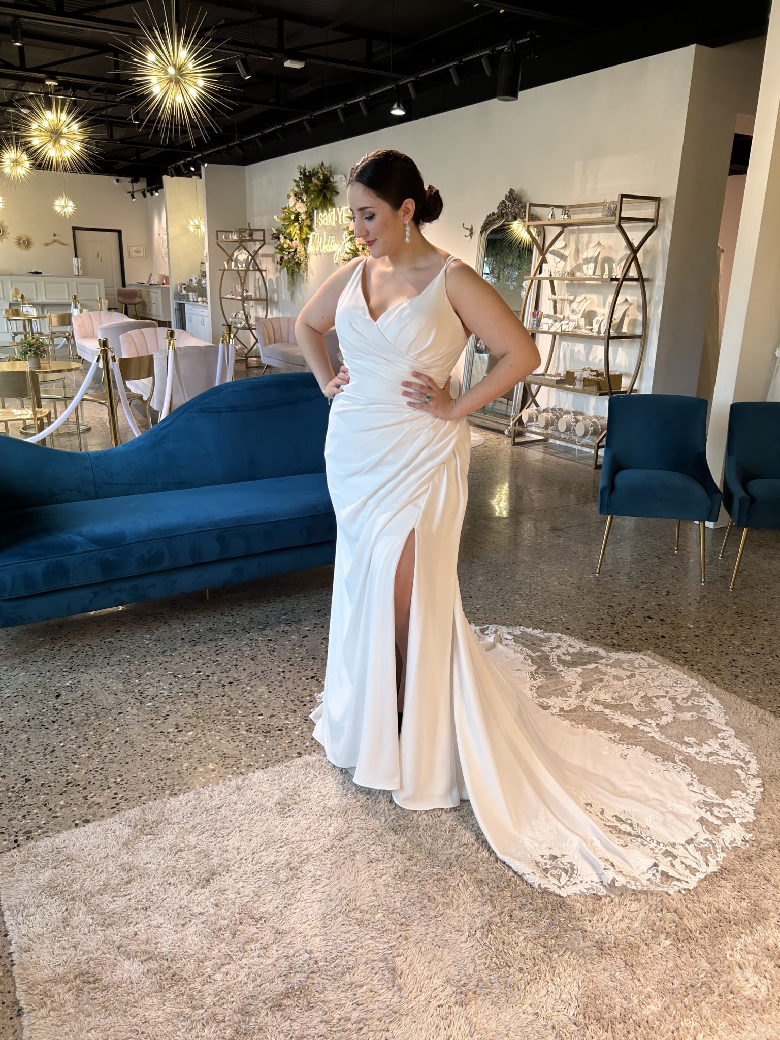 woman in white, ruched wedding dress which creates flowing ripples to the dress