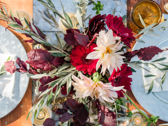 bright, colorful bouquet of flowers set on dinner table