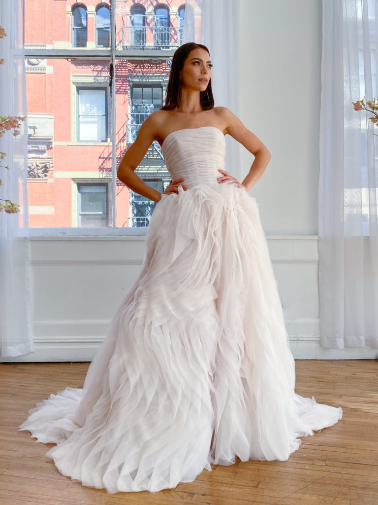 front of white bridal gown with ornately detailed bottom