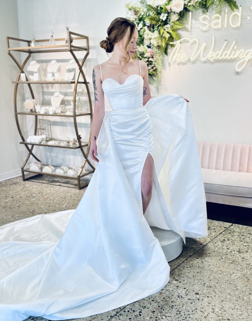 Kirsten is a fitted gown with a sweetheart neckline and high slit
