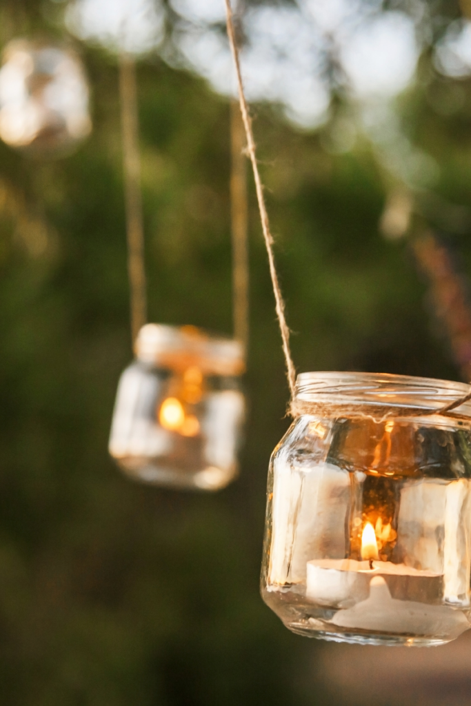 hanging mason jars with candles for a forest wedding reception