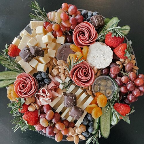 A charcuterie plate with meat, nuts, fruits, and cheese from The Grazing Table