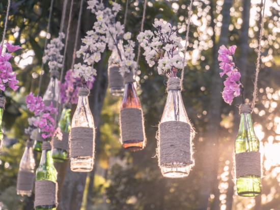 personalized decor hanging bottles with white and pink flowers in trees