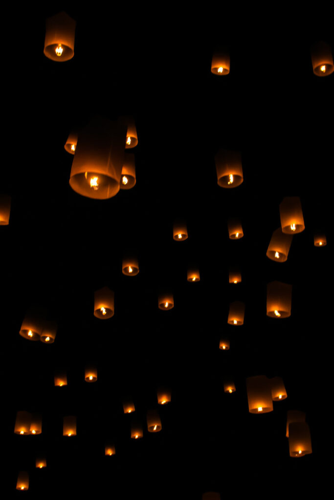 sky lanterns glowing in dark sky