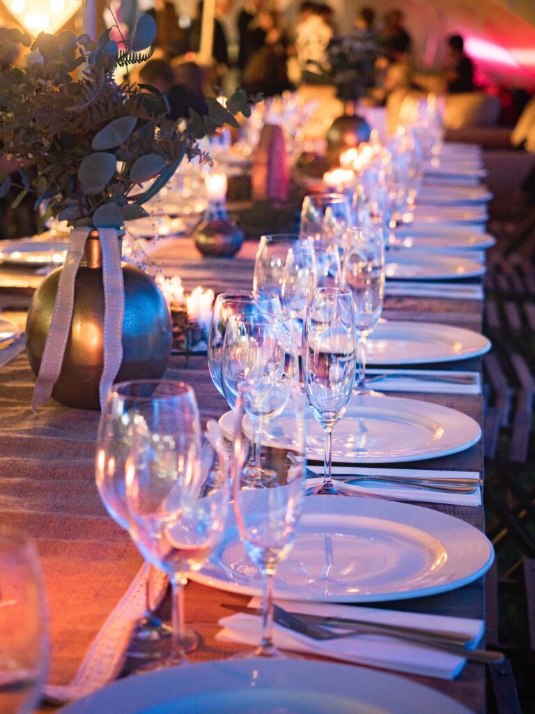 glimmering champagne glasses and centerpieces at a wedding rehearsal dinner venue