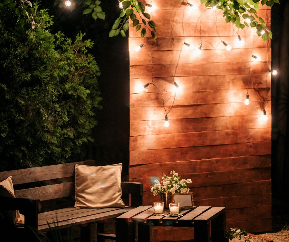cozy seating area with bench and fairy lights for a garden wedding