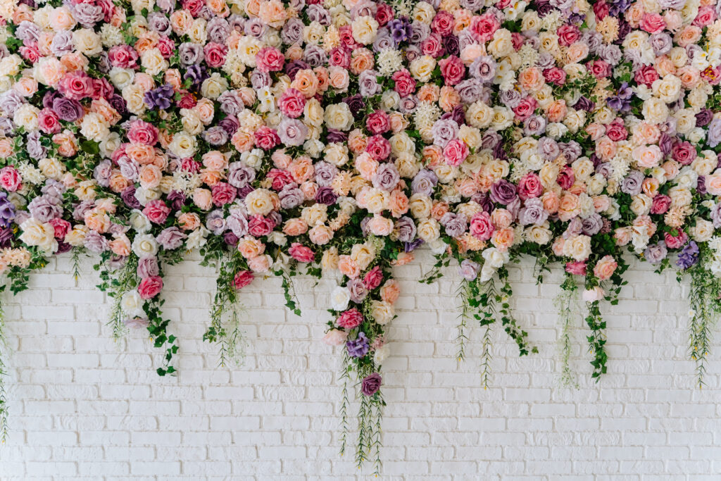 gorgeous floral wall with white brick for wedding photo backdrop