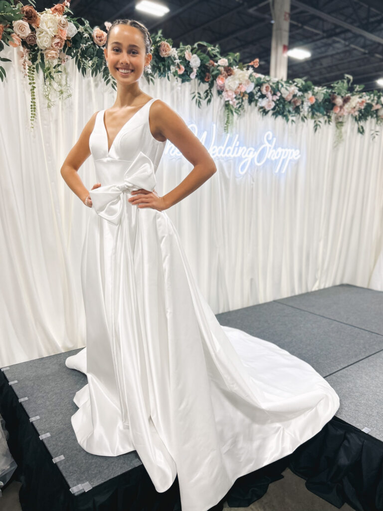 Kenedy is an a-line wedding dress made of satin with a bow