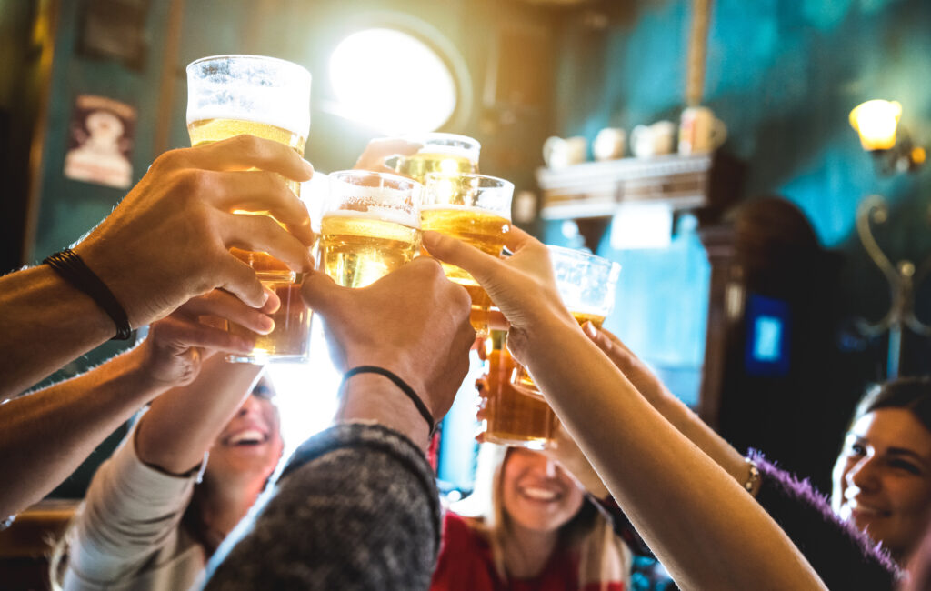 people having drinks at a local brewery for a wedding rehearsal dinner