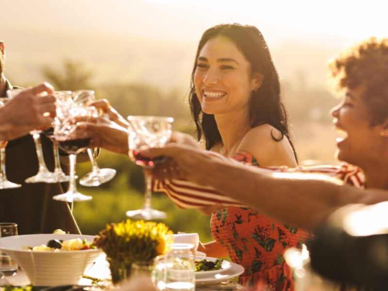 smiling people toasting at a wedding rehearsal dinner venue