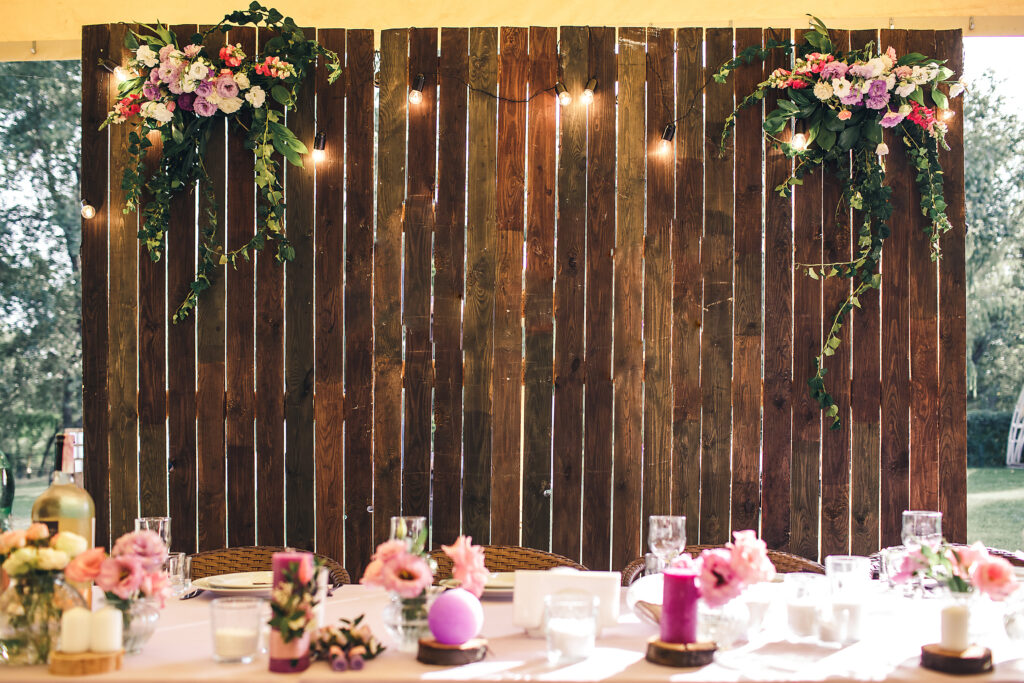 natural wood wall with floral details and twinkling lights for a fairytale wedding