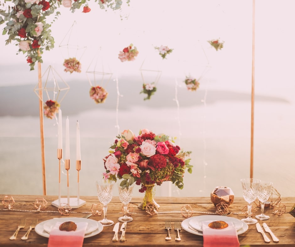 table set up with a bouquet of wildflowers along with geometric decor elements