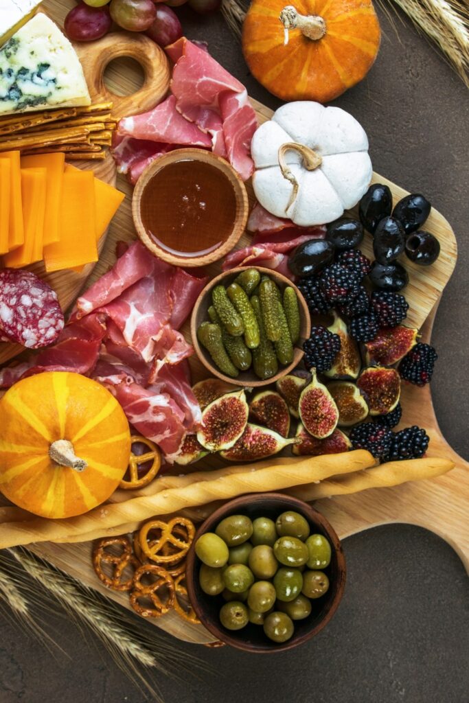 charcuterie board for an autumn wedding themed with fall decorations