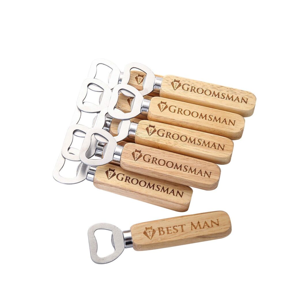 Bottle openers with wooden handle. The handles have a little tux and the word "groomsman" engraved. One bottle opener is off by itself and has the words "best man."