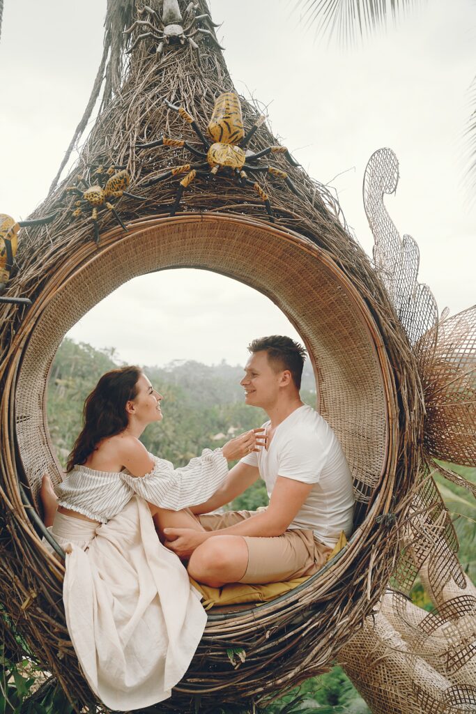 newly married couple in a wicker hammock on their honeymoon in love