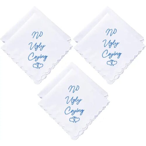 Three white handkerchiefs folded with blue embroidery saying "No Ugly Crying"
