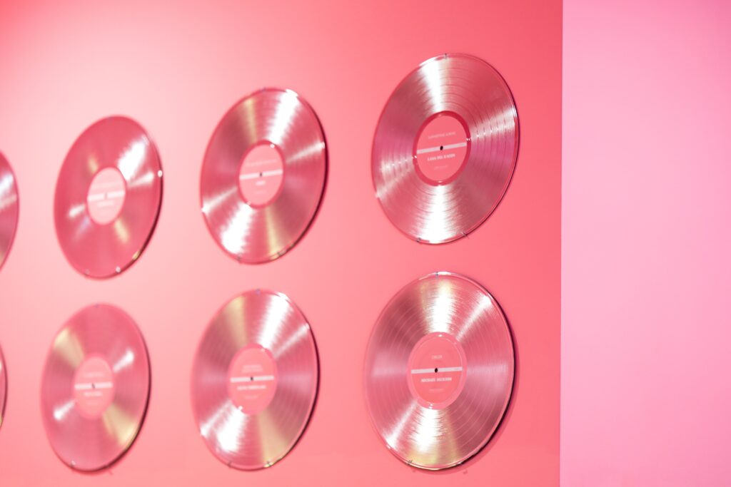 pink vinyl records on a pink wall for a retro wedding