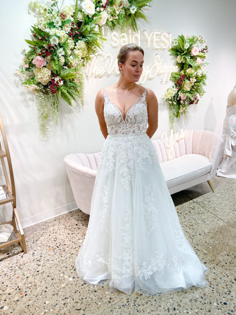 The Wedding Shoppe bride wearing lace bodice dress with lace appliques tapered down the tulle skirt.