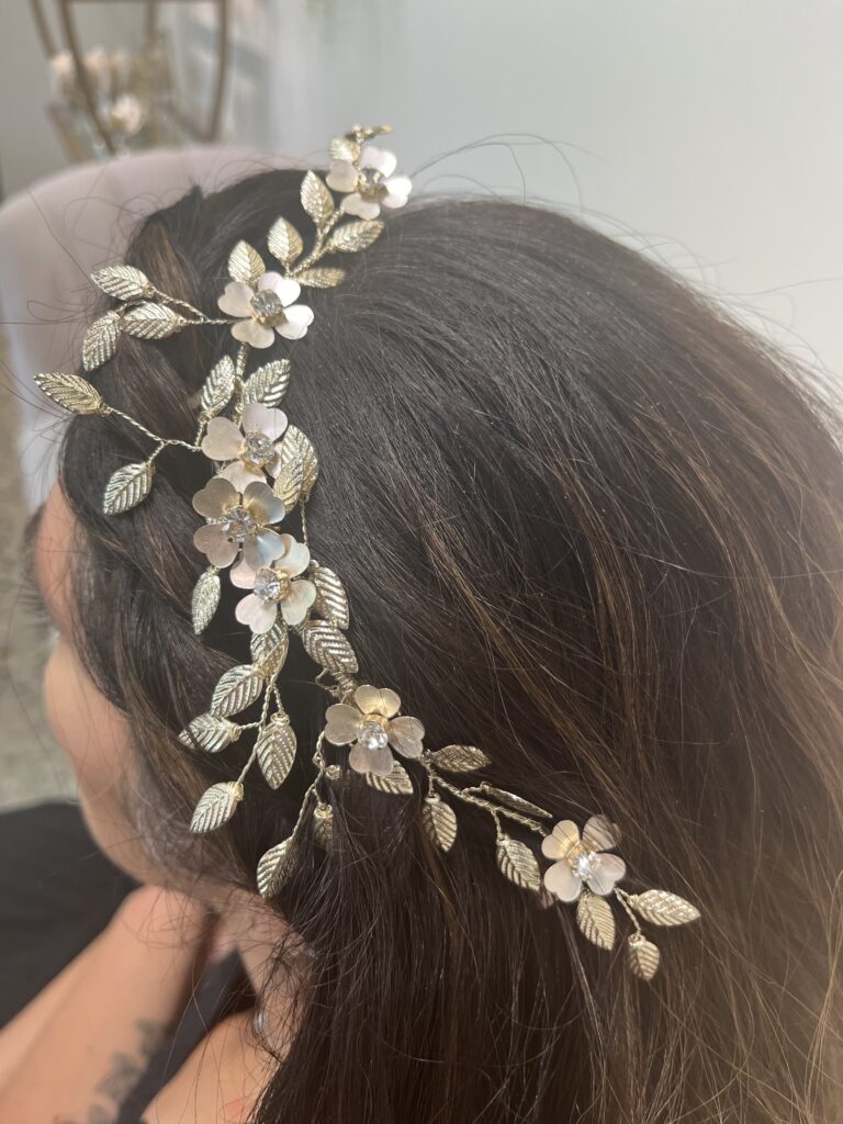 Bride wearing a gold leaf and floral comb embellished with crystals. The true star to this piece is the incredible artistry.