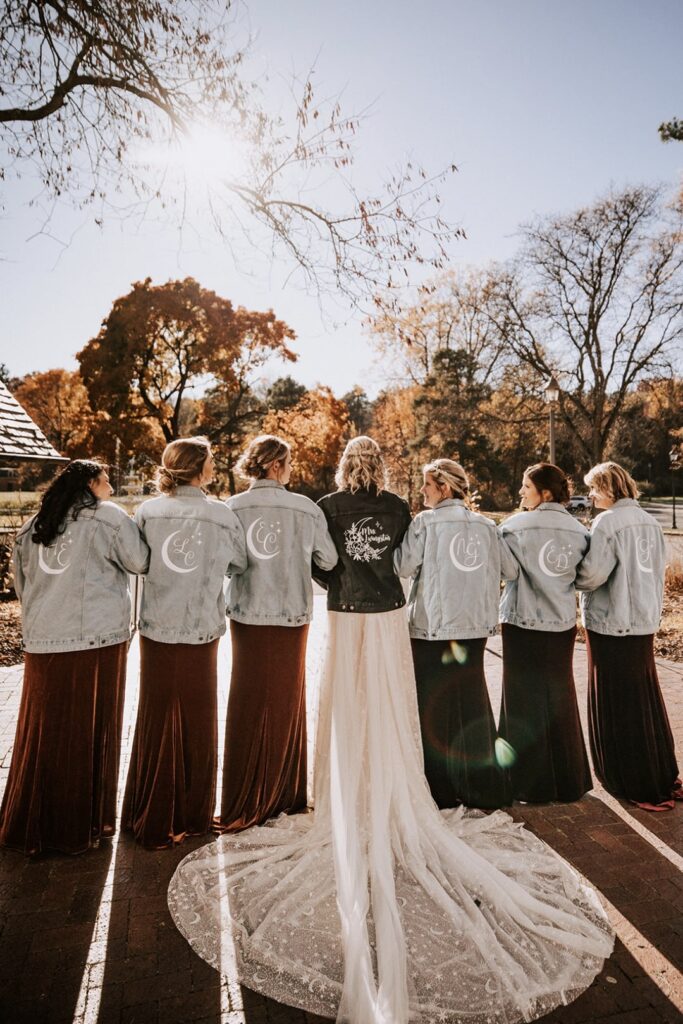 a bridal party with matching jackets for a fall wedding
