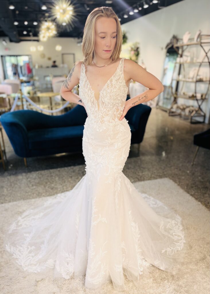 April Marie- is a plunging neckline gown with all over lace detail, delicate appliqué and sparkle