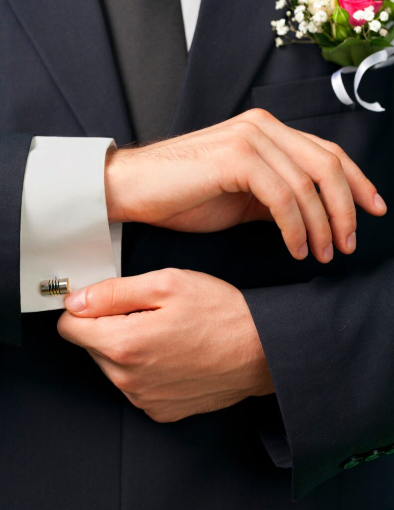 a groom adjusting his cufflinks