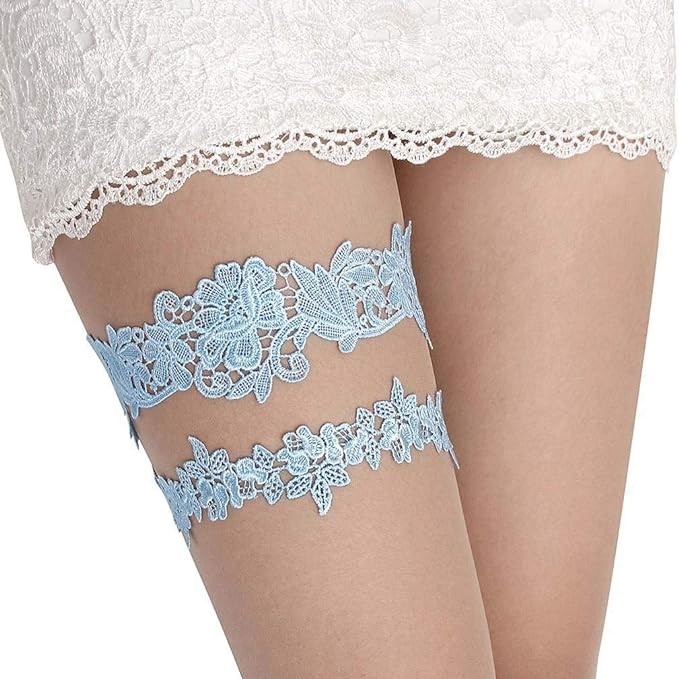 Blue, floral lace garters displayed on a woman's thigh.