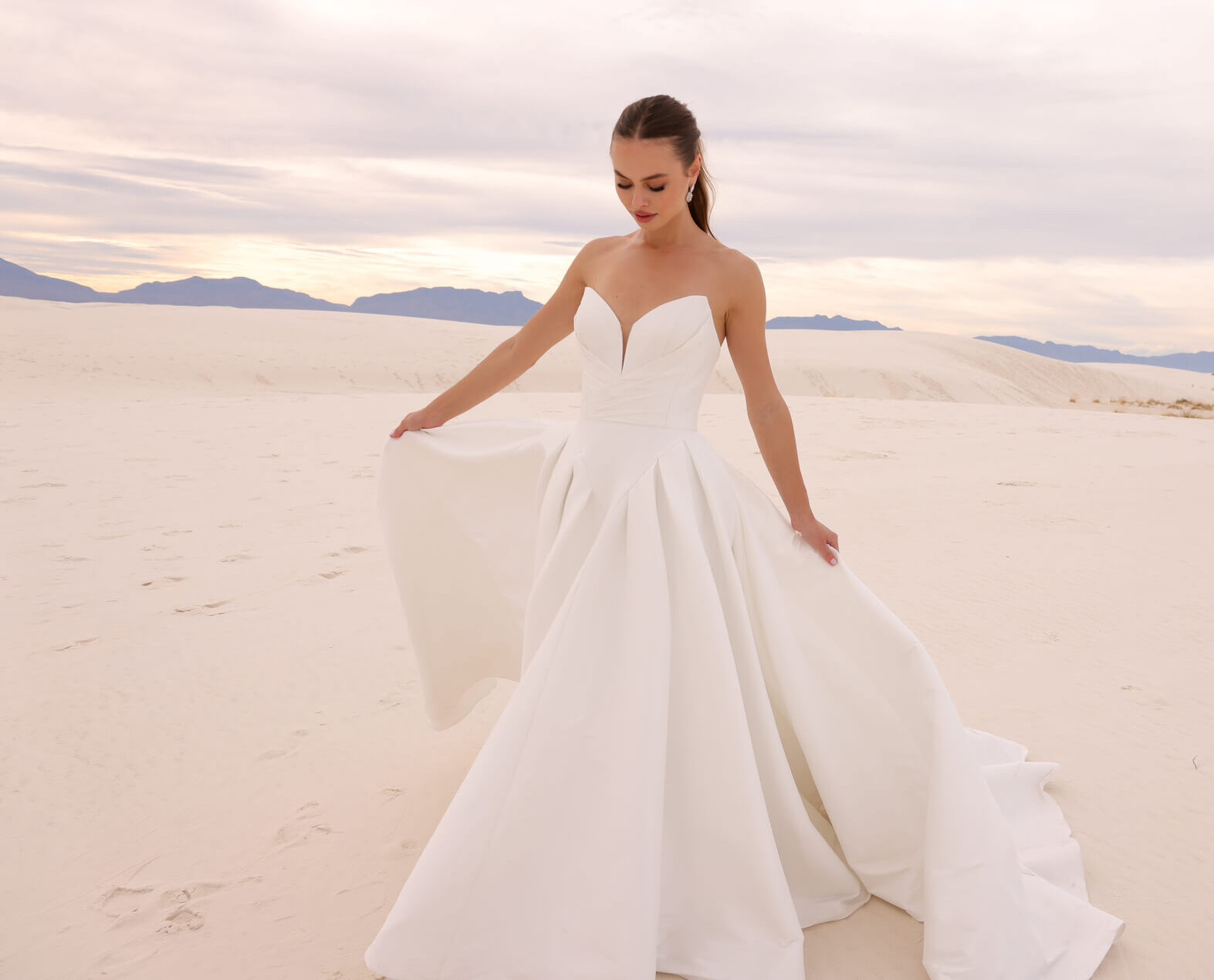 Jimme Huang bridal model walking in desert