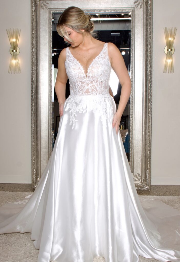 Enid is a simple satin faced organza gown with beautiful lace appliqué.