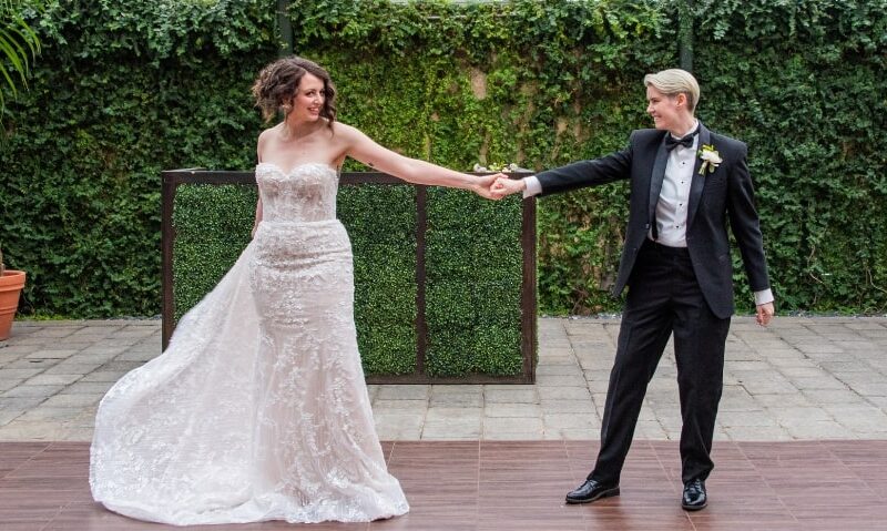 Corinne and Alicia at the Planterra Conservatory, wearing the Allure dress and the Randazzo Formalwear suit.