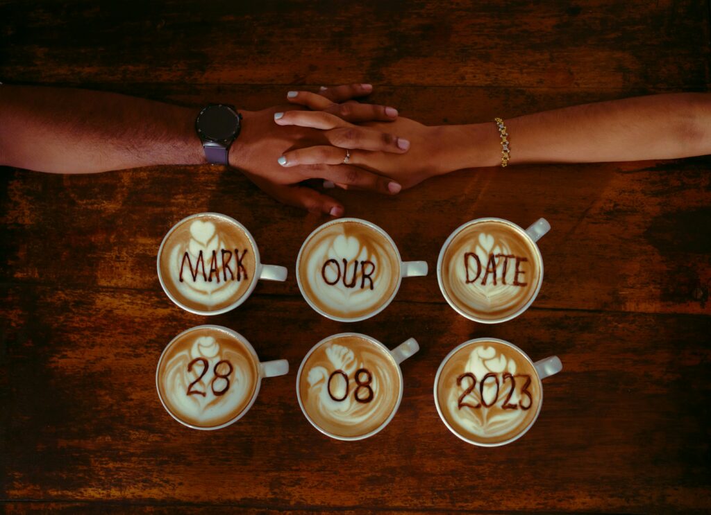 hands holding over save the date coffee art